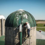 A Mennonite farmer watches his silo fill to the top as Jantzi and his crew bring in the crop.